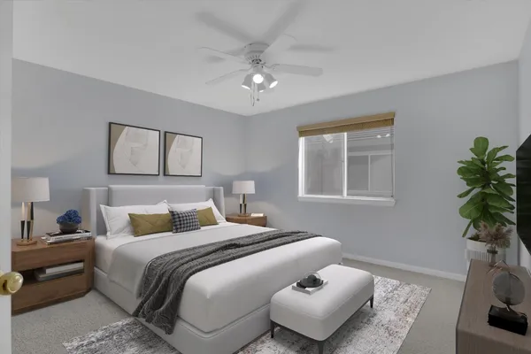 a bedroom with a bed and a potted plant