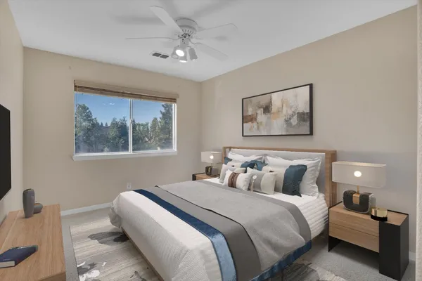 a bedroom with a bed and a painting on the wall