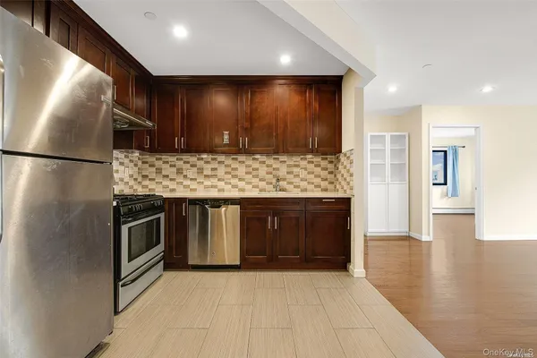 a view of a kitchen with a sink and a refrigerator