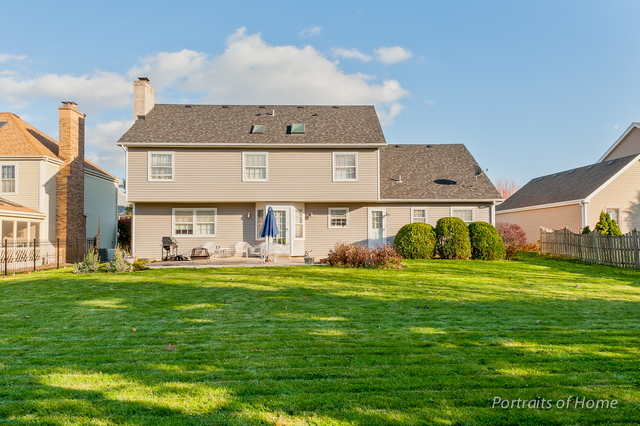 29 Christina Circle Wheaton, IL 60189 - Photo 19 of 28 a front view of a house with a garden