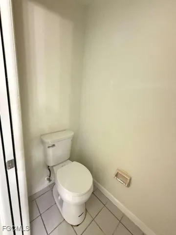 a white toilet sitting next to a sink