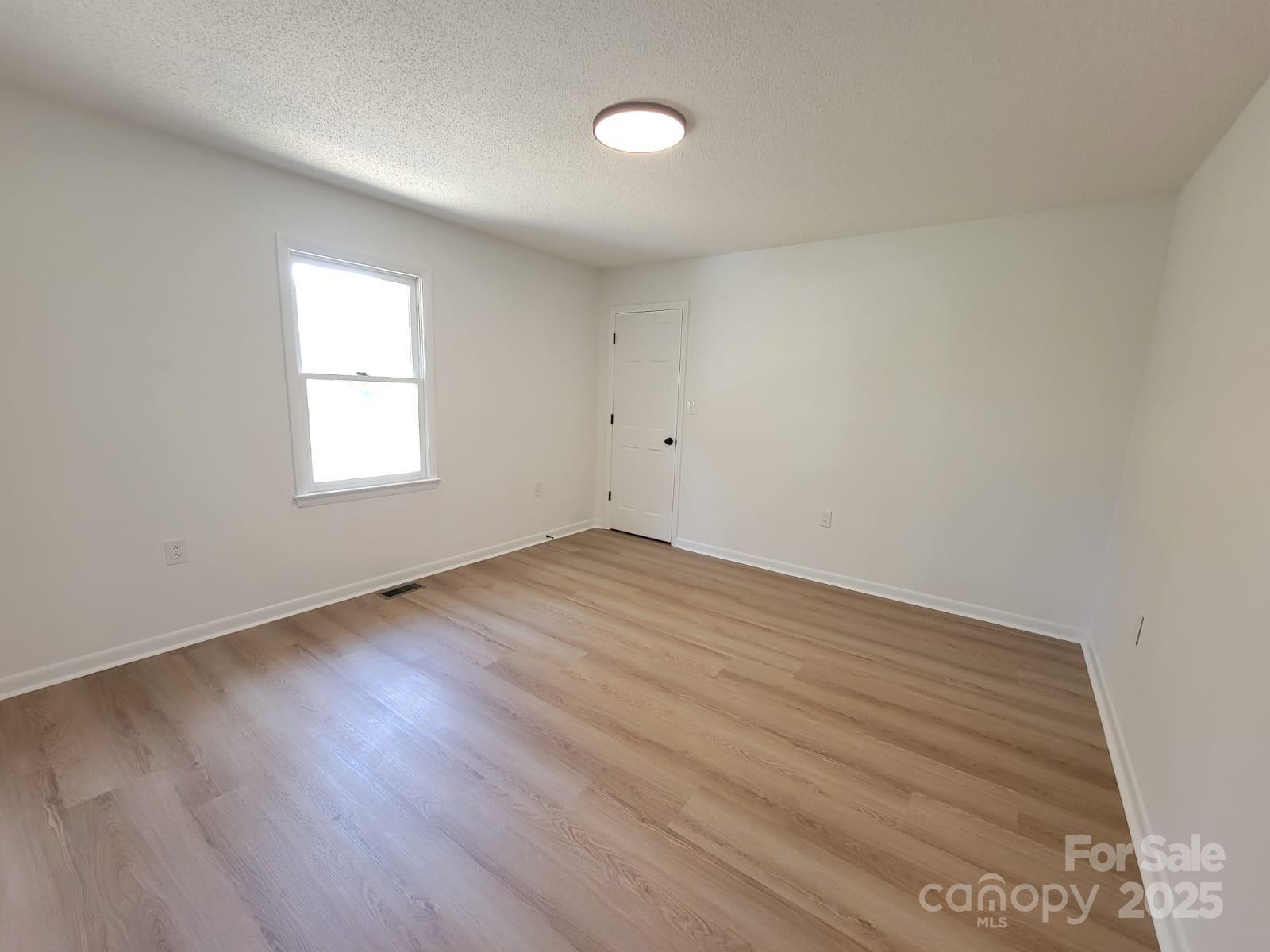 175 Pebble Drive Salisbury, NC 28147 - Photo 31 of 42 an empty room with wooden floor and windows