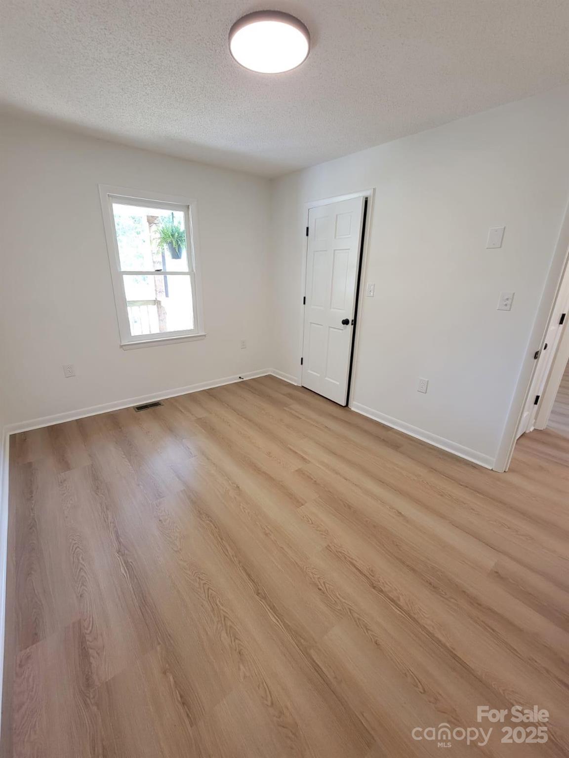 175 Pebble Drive Salisbury, NC 28147 - Photo 32 of 42 an empty room with wooden floor and windows