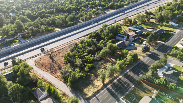 1792 Valley View Drive Layton, UT 84040 - Photo 8 of 18 Aerial perspective showcasing a major transportation corridor, surrounding residential areas, and abundant mature trees