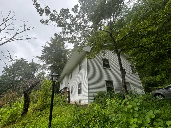a house that has tree in front of it