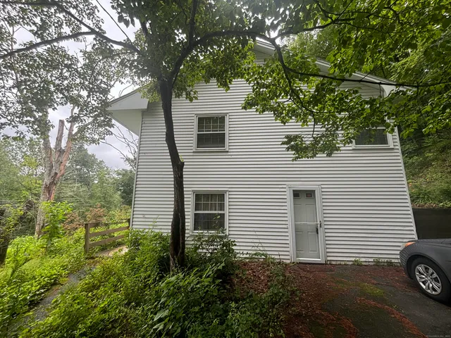 a view of a house with a tree