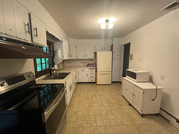a kitchen with a stove a sink and a refrigerator