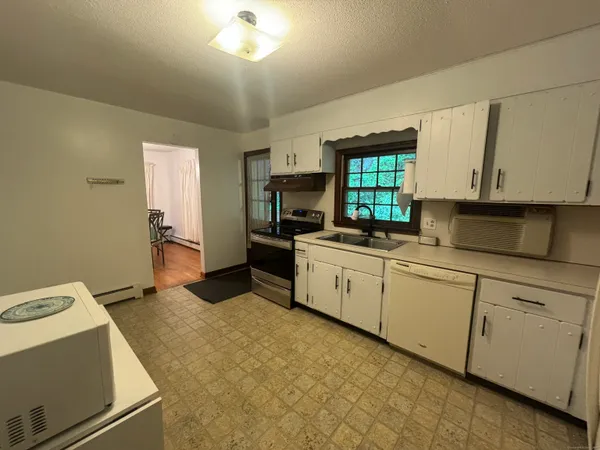 a view of a dining room with furniture and window