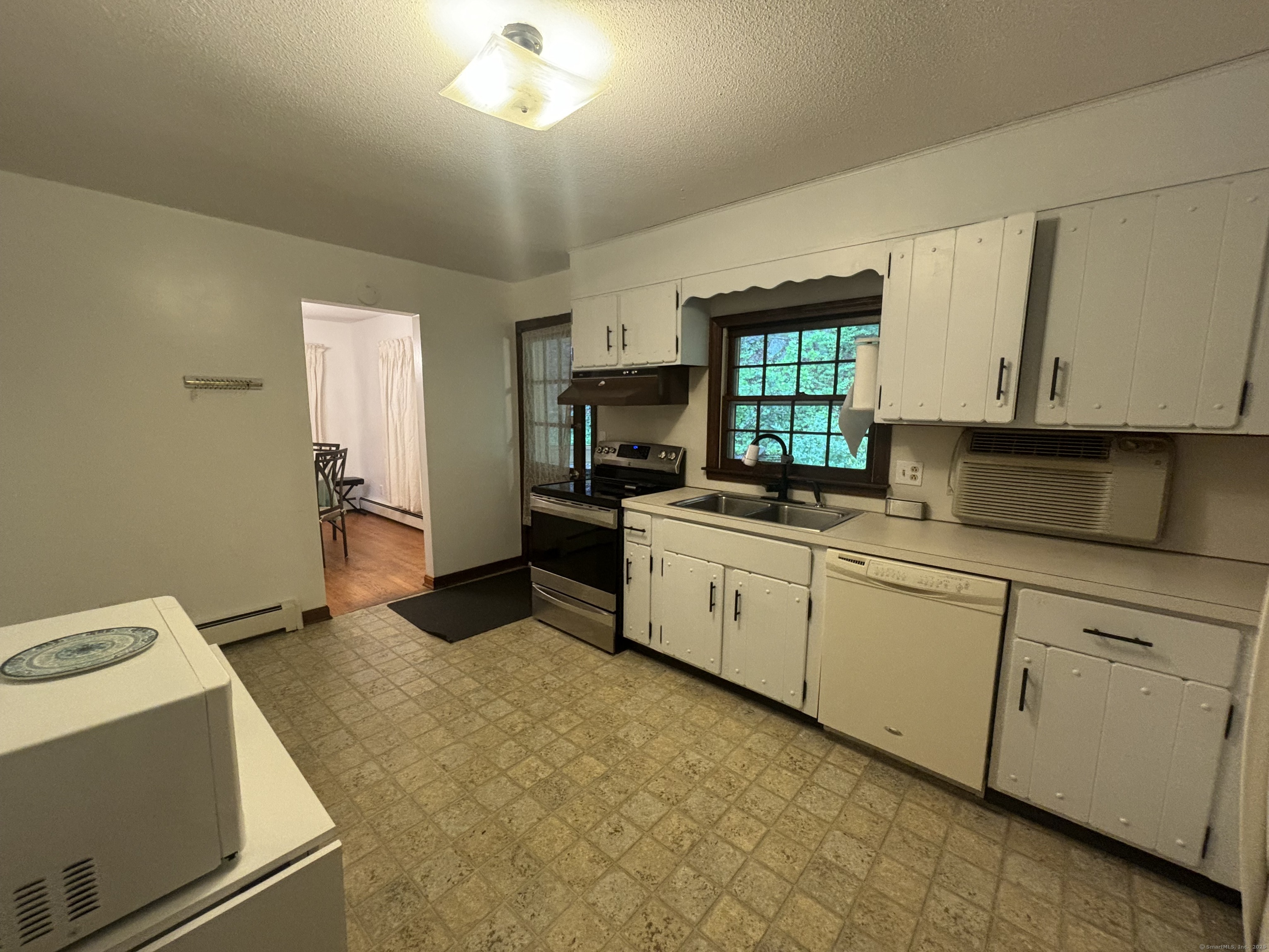 388 Chaffeeville Road Mansfield, CT 06268 - Photo 6 of 13 a kitchen with a stove a sink and a refrigerator