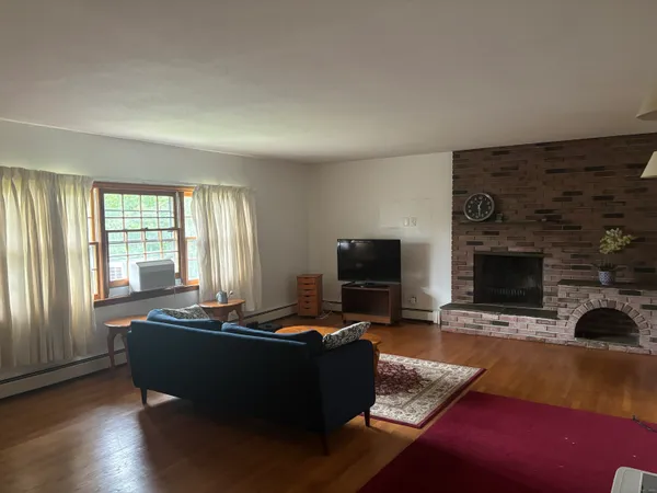 a living room with furniture rug and window