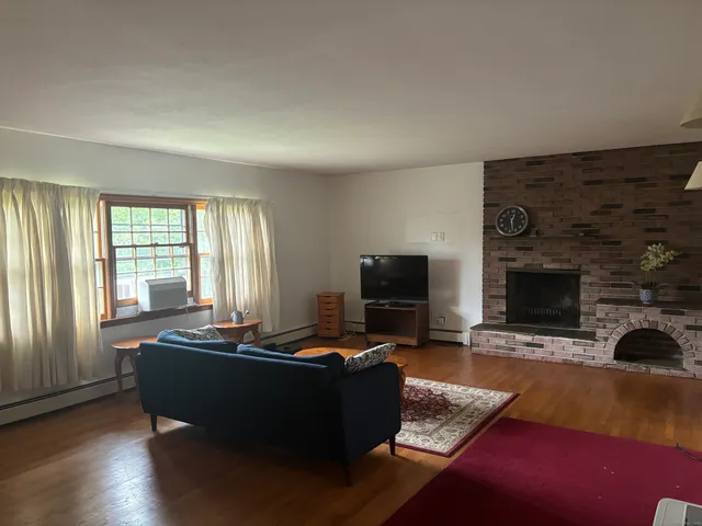 a living room with furniture rug and window