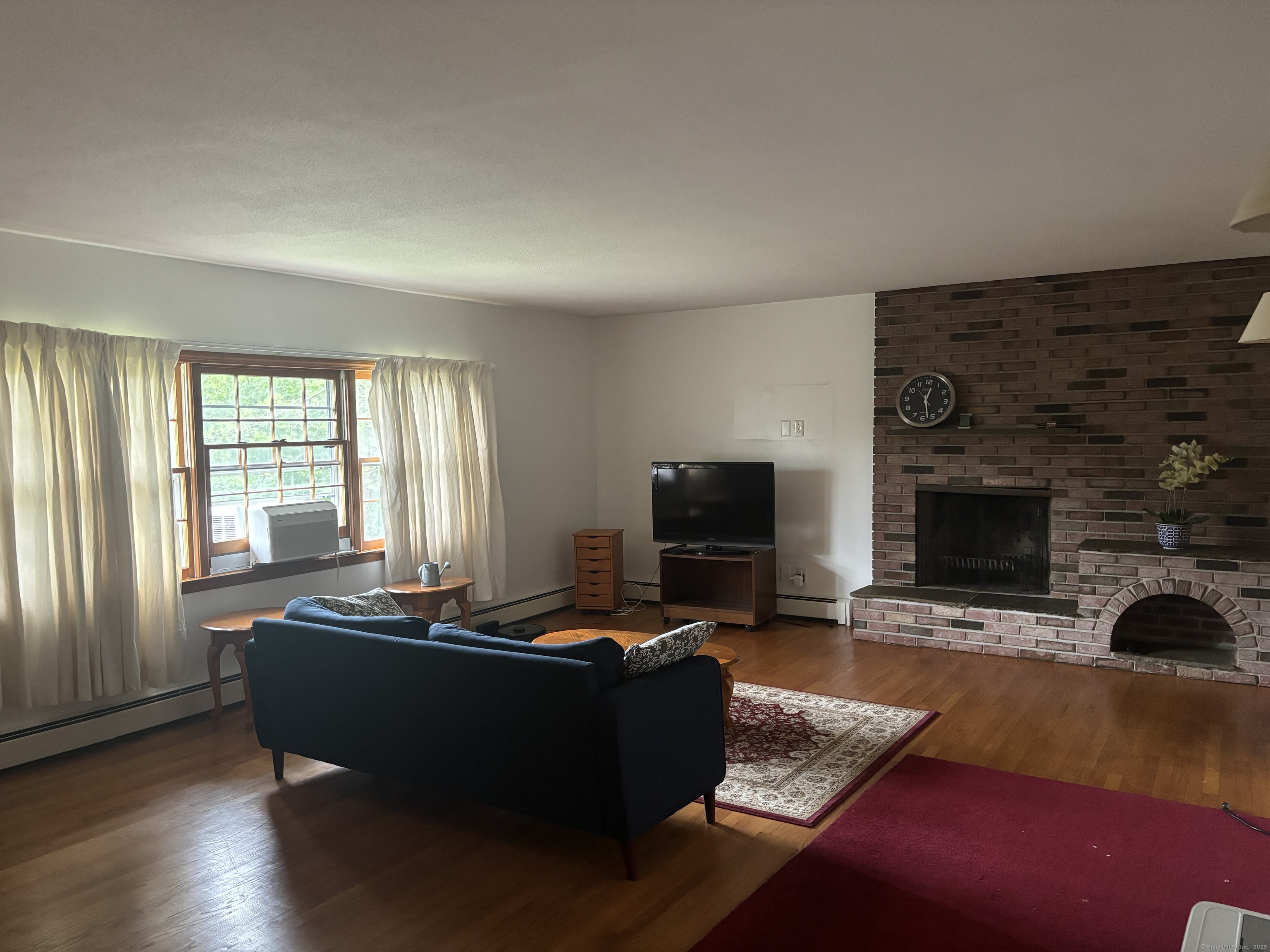 388 Chaffeeville Road Mansfield, CT 06268 - Photo 8 of 13 a living room with furniture and a fireplace