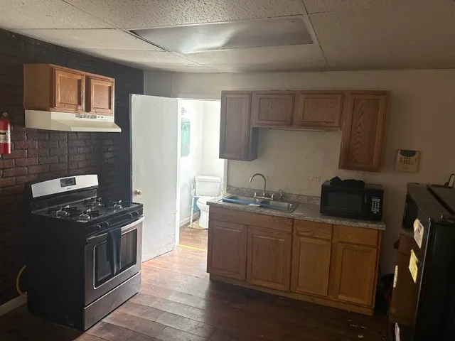 a kitchen with stainless steel appliances a stove sink and refrigerator