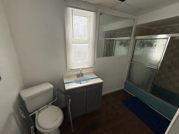 a white toilet sitting next to a window