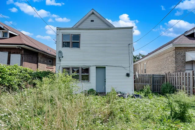 a front view of a house with plants