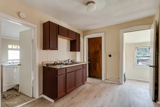 a kitchen with granite countertop a stove and a refrigerator
