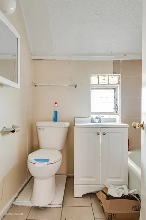 a bathroom with a toilet sink and mirror