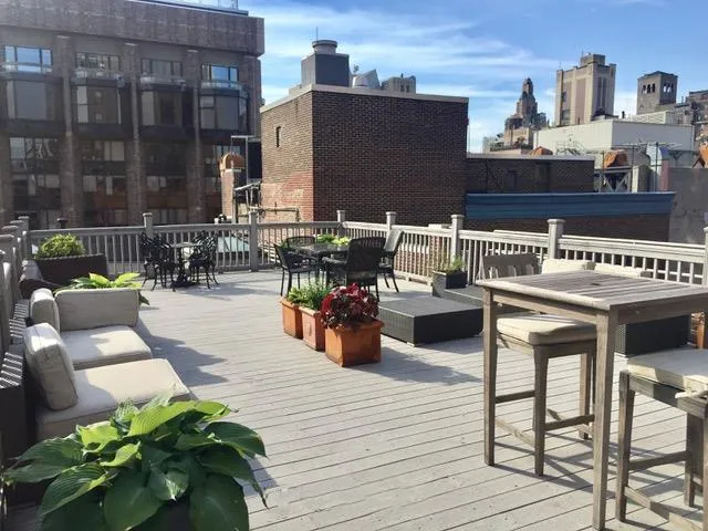 a view of balcony with seating space and wooden floor