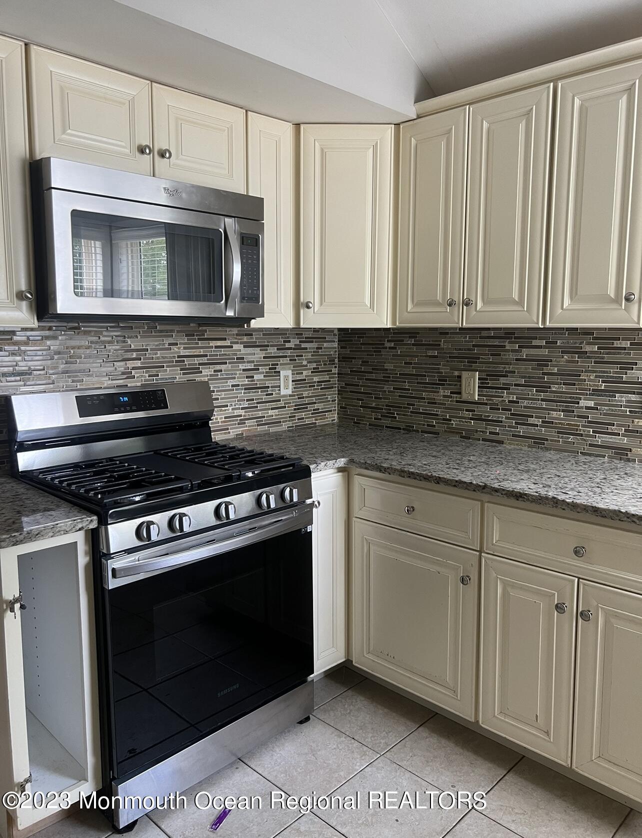 11 Barbara Lane Oakhurst, NJ 07755 - Photo 2 of 10 a kitchen with granite countertop white cabinets and stainless steel appliances