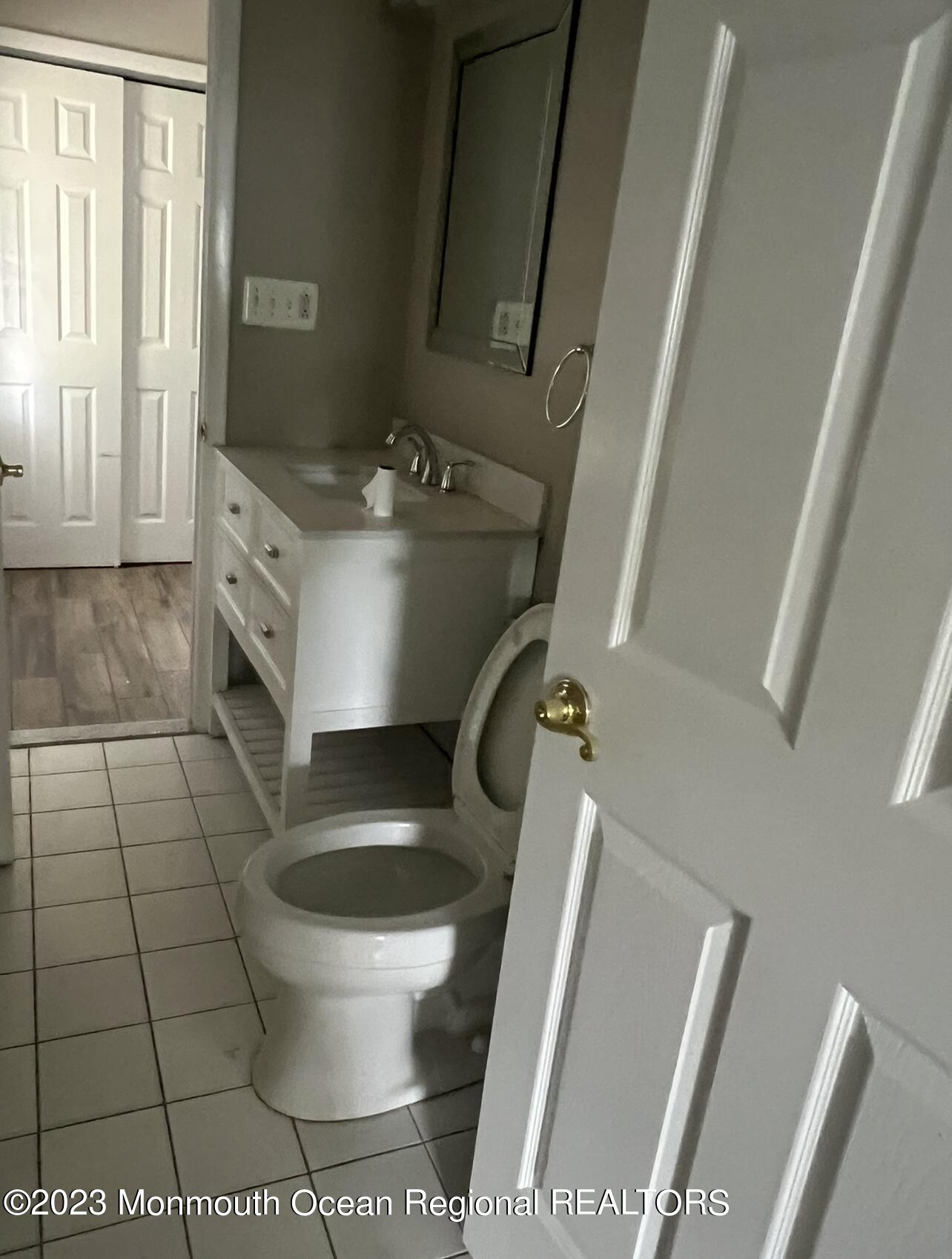 11 Barbara Lane Oakhurst, NJ 07755 - Photo 8 of 10 a bathroom with a toilet and a mirror