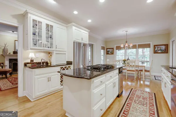 a kitchen with stainless steel appliances granite countertop a stove and a refrigerator