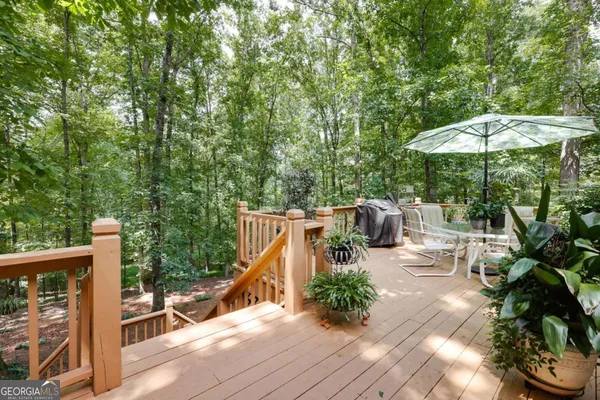 a view of backyard with table and chairs and a barbeque