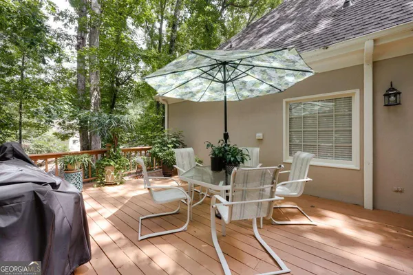 a view of a patio with table and chairs and potted plants