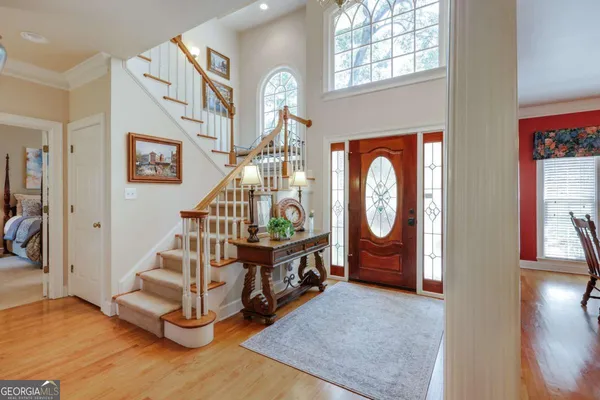 a view of an entryway with wooden floor and a front door