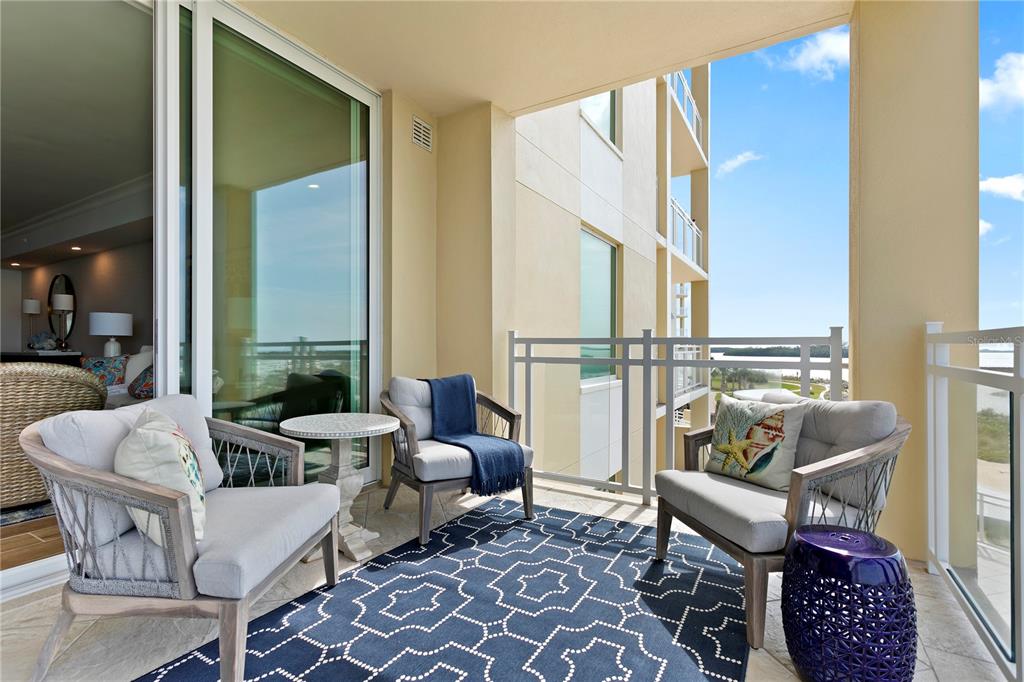 800 Collany Road, Unit 303 St. Petersburg, FL 33715 - Photo 27 of 48 a living room with furniture and a floor to ceiling window