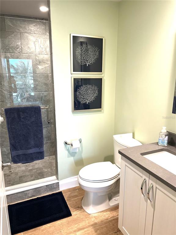 800 Collany Road, Unit 303 St. Petersburg, FL 33715 - Photo 28 of 48 a bathroom with a granite countertop toilet sink and mirror