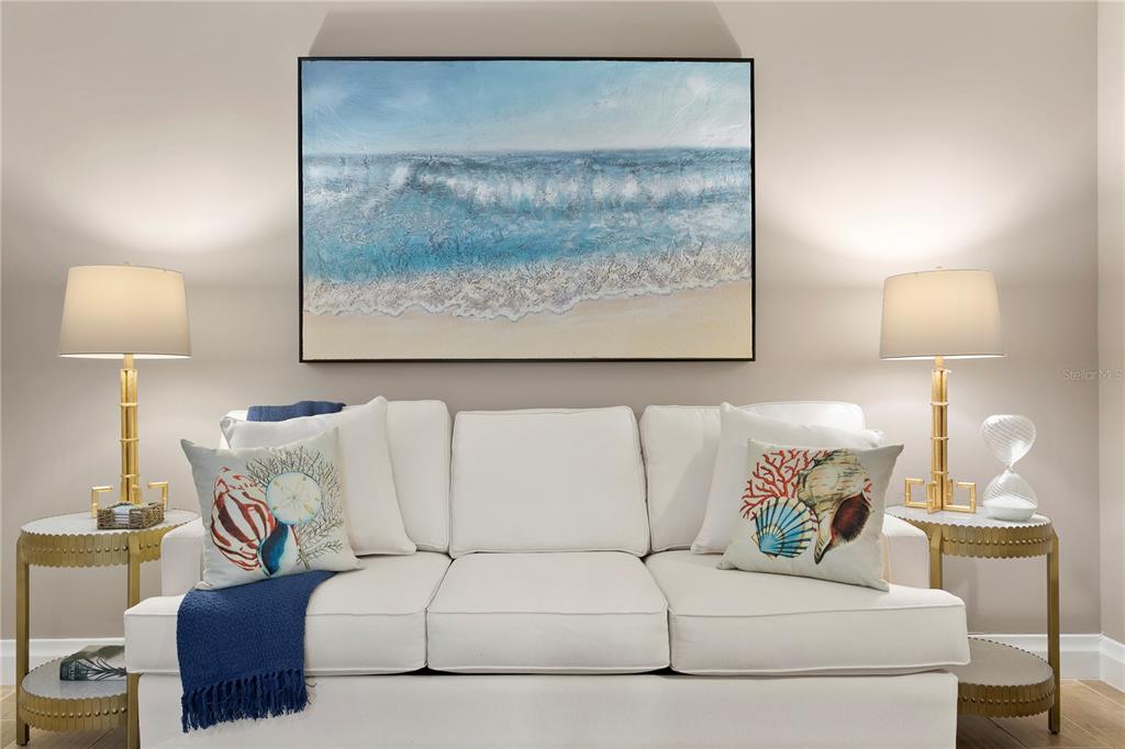 800 Collany Road, Unit 303 St. Petersburg, FL 33715 - Photo 30 of 48 a living room with a couch and a lamp on dresser