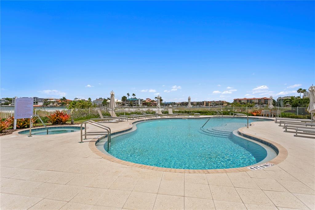 800 Collany Road, Unit 303 St. Petersburg, FL 33715 - Photo 34 of 48 a view of a swimming pool with a table and chairs