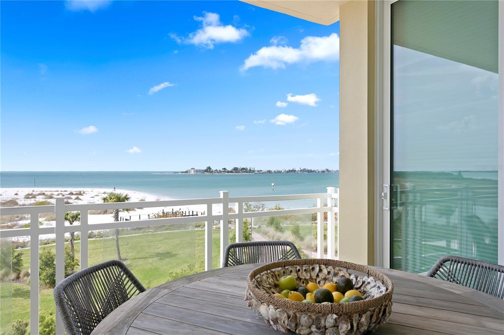 800 Collany Road, Unit 303 St. Petersburg, FL 33715 - Photo 4 of 48 a balcony with furniture and a lake view