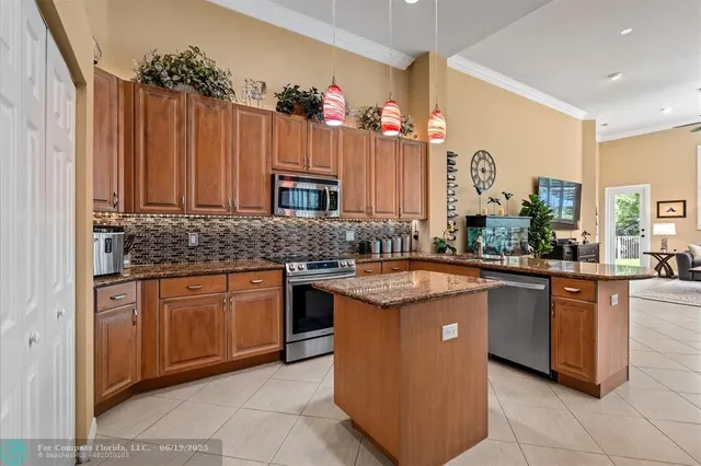 a kitchen with stainless steel appliances a sink stove and refrigerator