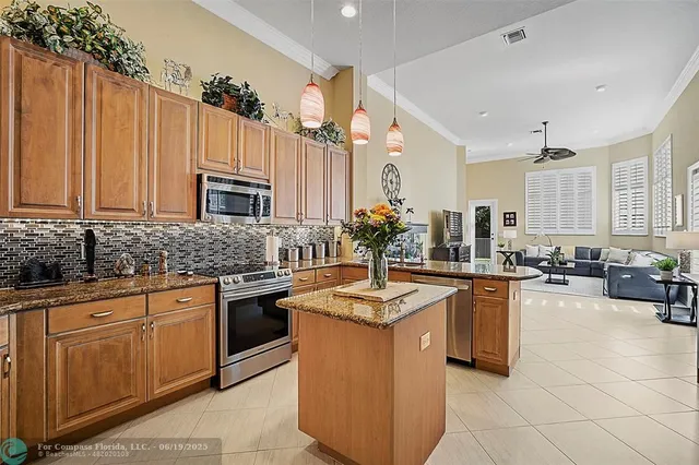 a living room with furniture a flat screen tv and large window