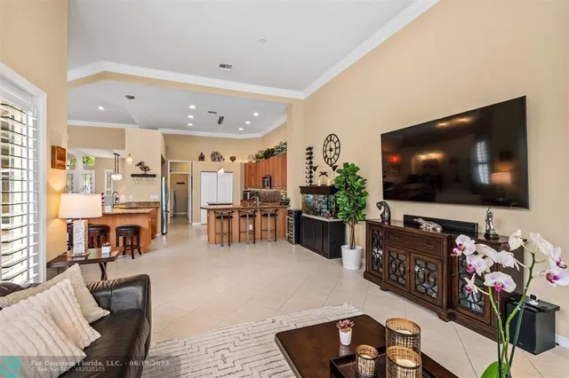 a spacious bedroom with a bed a couch and a chandelier