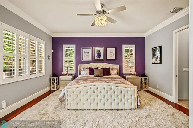 a bedroom with a large bed and a chandelier