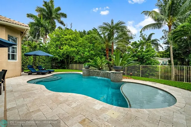 a swimming pool with outdoor seating yard and patio