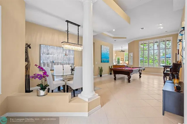 a living room with furniture and a floor to ceiling window