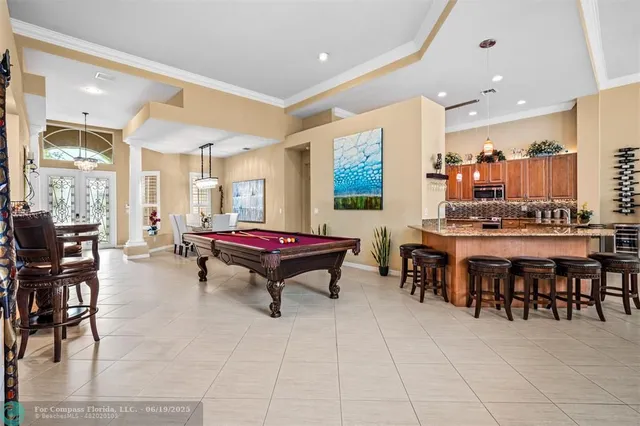a kitchen with stainless steel appliances granite countertop a sink and a white cabinets