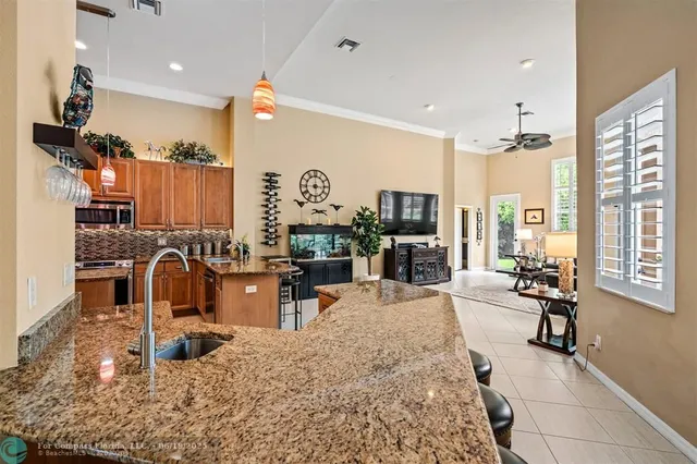 a kitchen with stainless steel appliances granite countertop a stove a sink and a refrigerator