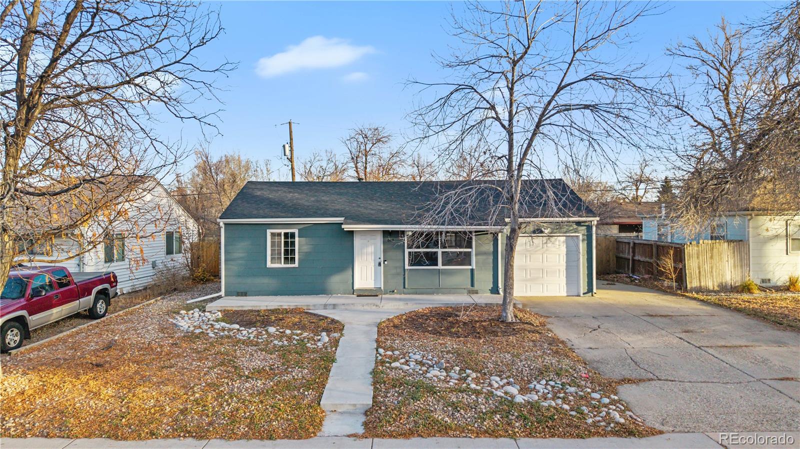 860 Lansing Street Aurora, CO 80010 - Photo 2 of 31 a front view of house with yard covered in snow