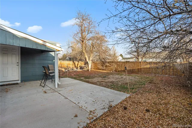 a view of a house with a yard and sitting area