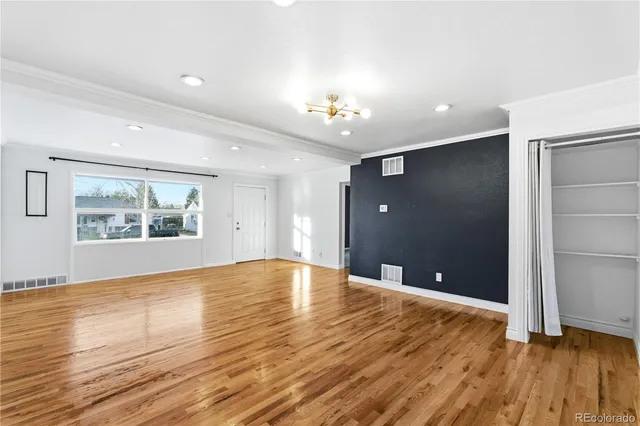 wooden floor in an empty room with a window
