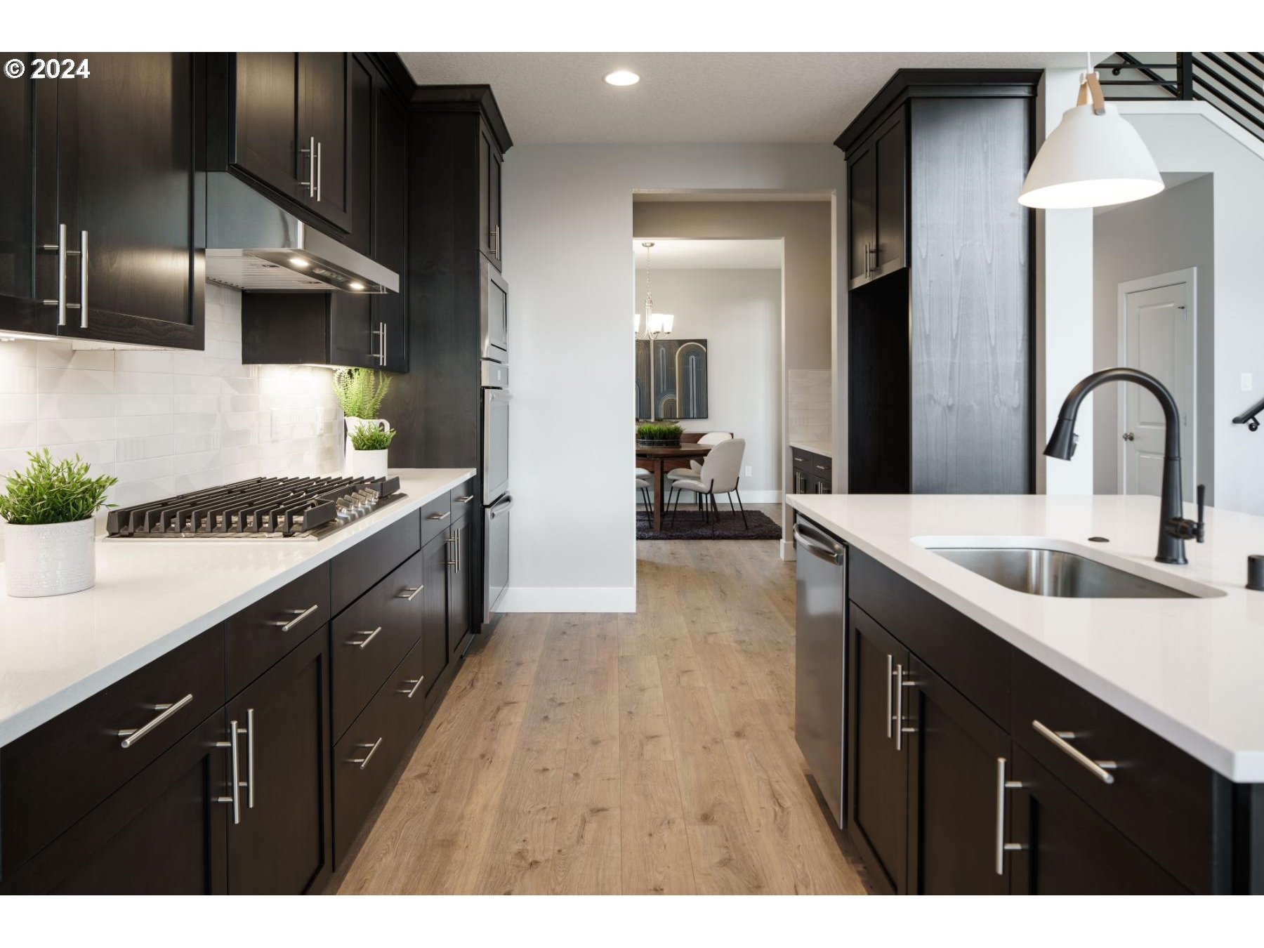 4219 North 11th Way Ridgefield, WA 98642 - Photo 11 of 32 a kitchen with a sink cabinets and wooden floor