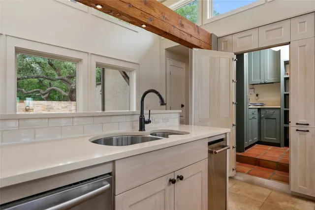 a kitchen with a sink and large window