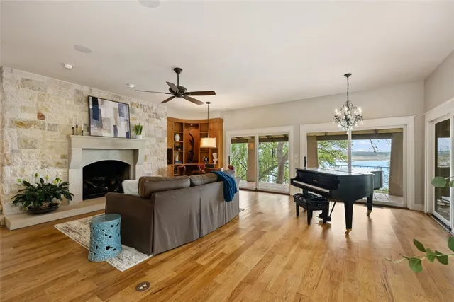 a living room with furniture two windows and a fireplace