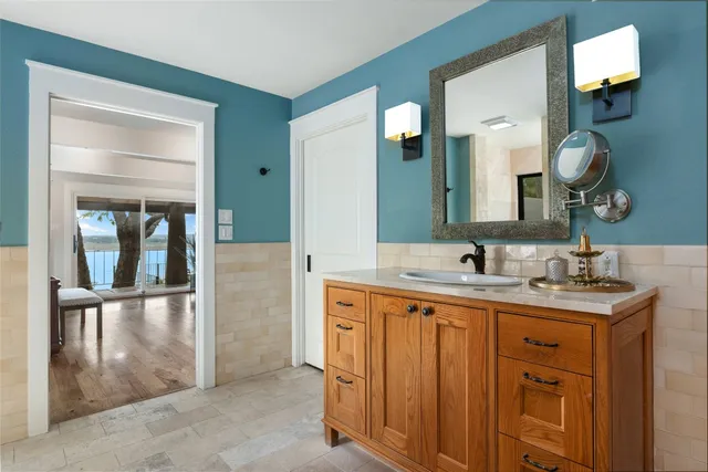 a bathroom with a granite countertop sink a large mirror and a