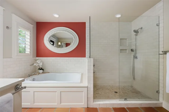 a bathroom with a bathtub and a shower