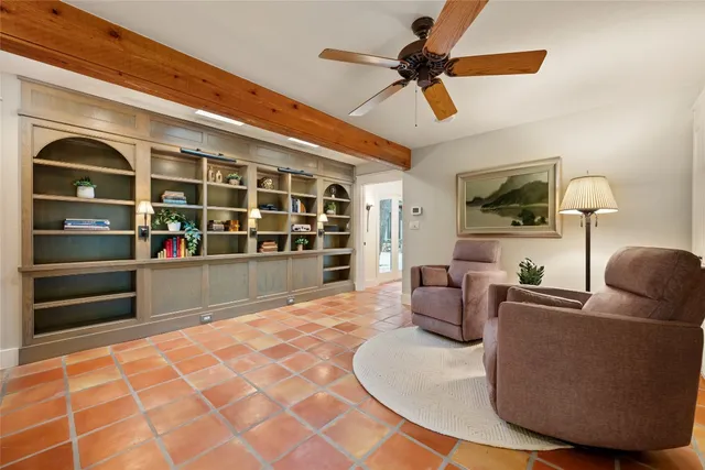 a living room with furniture and a floor to ceiling window